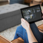 Person Looking at Home Security Cameras on a Mobile Device